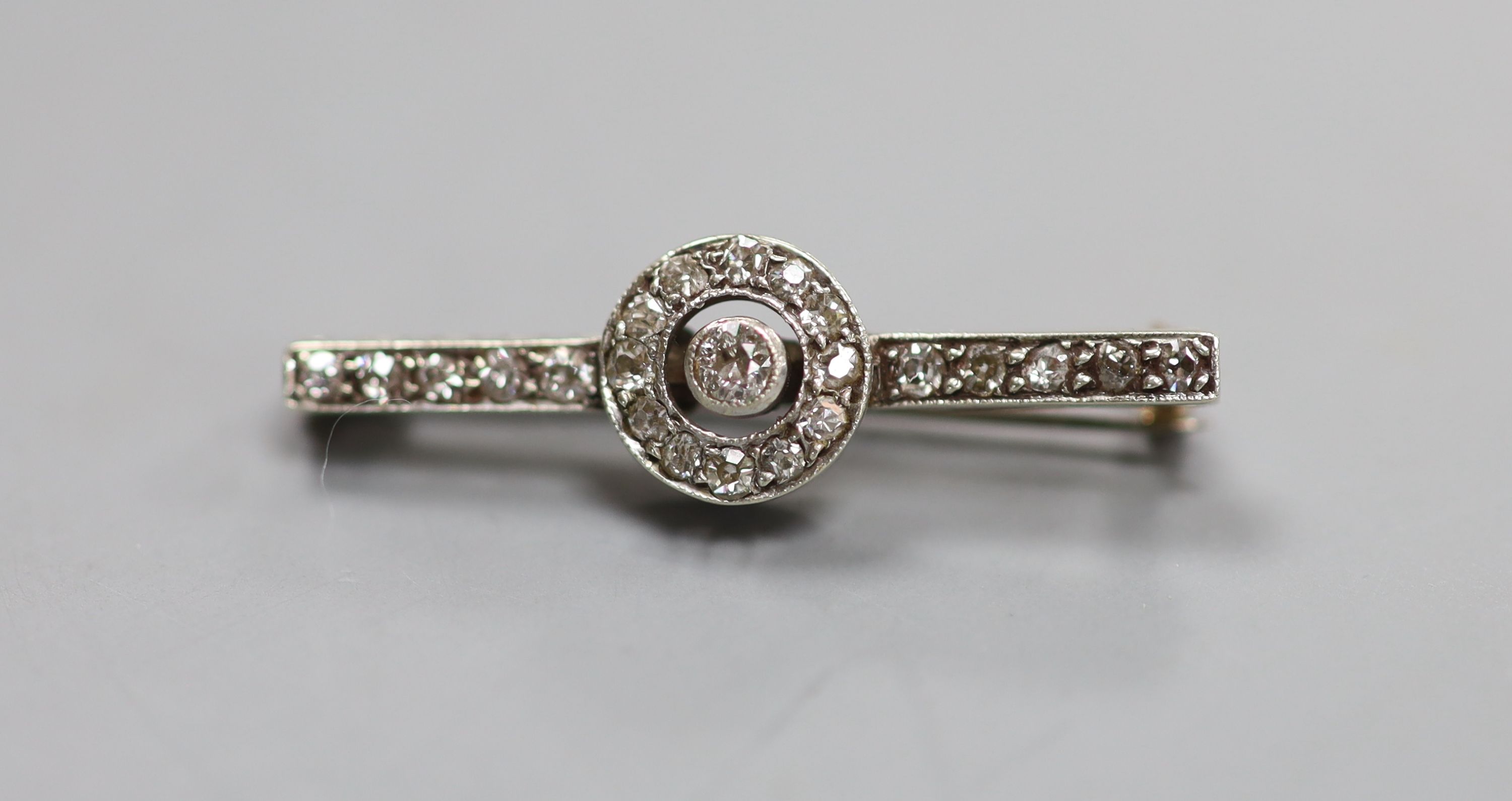 An early 20th century white metal (stamped 9ct) and diamond target cluster set bar brooch